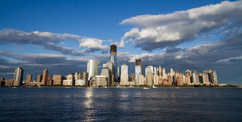 Lower Manhattan skyline with Freedom Tower and skyscrapers on summer day with blue sky