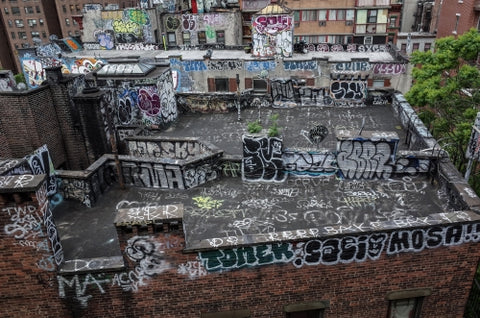 graffiti all over building rooftop - roof with spray paint vandalism art in Brooklyn