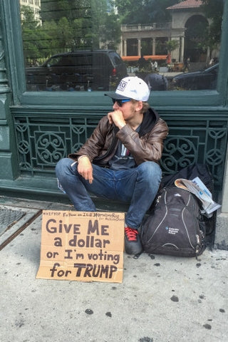 guy on street with homeless sign - Trump hate in NYC