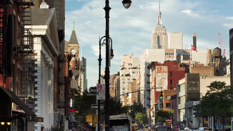 Empire State Building and Jefferson Market Library clock tower view from Greenwich Village on summer day in NYC