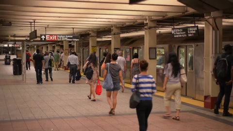 people getting off train on subway platform in station - summer in NYC