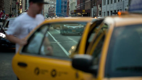 two men getting into taxi cab on Lafayette Street in Cooper Square Manhattan NYC