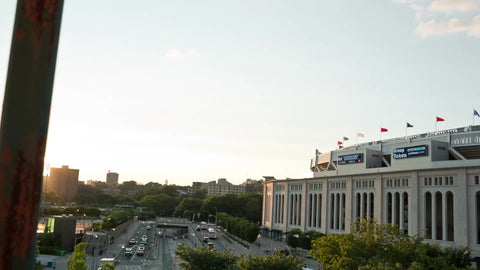 Yankee Stadium at sunset on beautiful summer day - view from elevated subway train platform in the Bronx in NYC