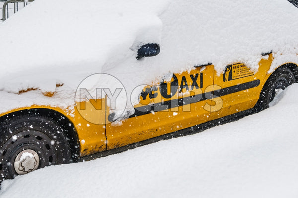 taxi cab covered in snow - snowing in winter storm