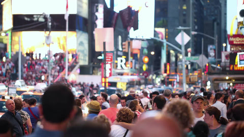 Times Square with many people walking - crowded in street on summer night