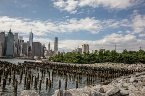 wooden dowels on East River water with Manhattan skyline in New York City
