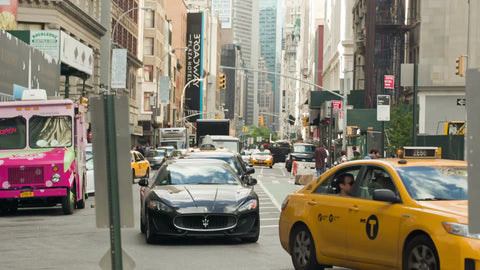 cars on one lane street in summer - Flatiron District in Manhattan on summer day