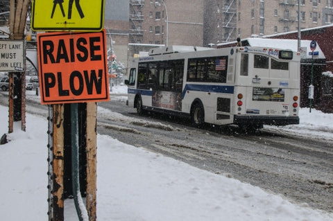 raise plow sign in winter - snowing in Manhattan - MTA bus driving on snow in winter - slush in street