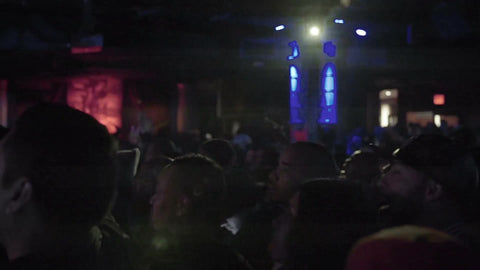 silhouettes of fans in crowd at hip hop show