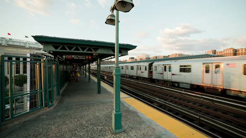 subway train across elevated track in the Bronx at Yankee Stadium in late afternoon NYC