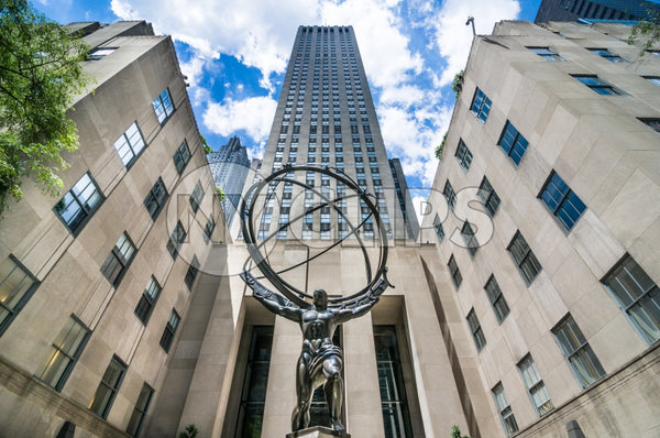 Atlas Statue in front of Rockefeller Center on beautiful blue sky day in Midtown Manhattan NYC
