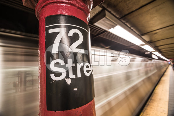 72nd street subway sign on platform pillar with blurred motion train entering station in NYC