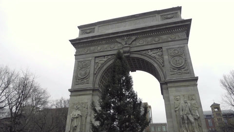 Washington Square Park arch and Christmas tree tilting down to Rolls-Royce luxury car on Lower 5th Ave 1080