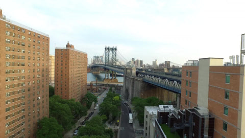 aerial view backing up from Manhattan Bridge to affordable housing buildings in Lower East Side neighborhood