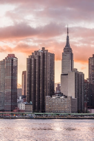 Empire State Building and skyscrapers in HDR at sunset from across East River water waves in Manhattan