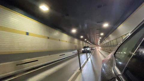 driving in Brooklyn-Battery Tunnel looking back at cars in other lane New York City NYC