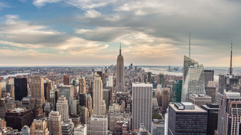 zooming out from Empire State Building cityscape 4K timelapse day to night - skyscrapers in Manhattan
