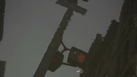 traffic light reflection in dirty puddle on ground in New York City NYC