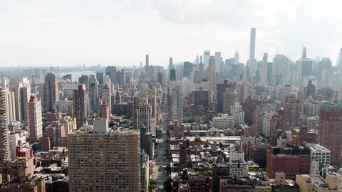 aerial pulling back Midtown Manhattan Empire State Building cityscape buildings New York City NYC