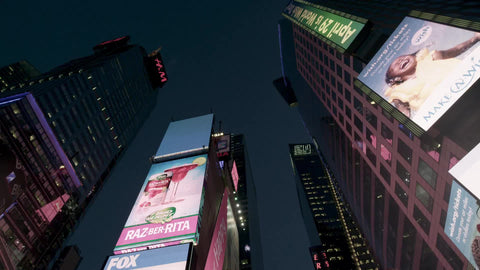 driving through Times Square with upward angle from moving car at night in New York City