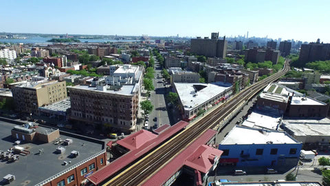 flying over subway tracks and gritty street in the Bronx - aerial