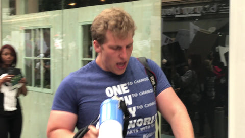 man with bullhorn chanting it's their flesh milk eggs at vegan march animal cruelty protest in New York City