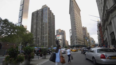 Flatiron Building on Lower Fifth Avenue with famous 5th Ave clock on warm spring day in Manhattan in 4K and 1080 HD in NYC