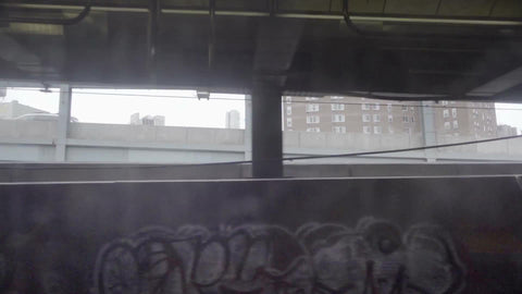 subway view of graffiti on gritty Brooklyn wall from moving B train in 1080 HD in NYC