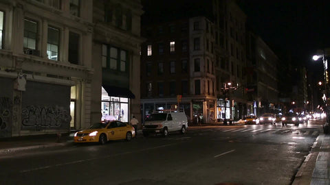 taxis driving down Broadway at night graffiti on gate taxicabs in Manhattan NYC