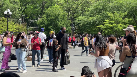 street acrobat jumping over line of volunteers people in Washington Square Park New York City NYC