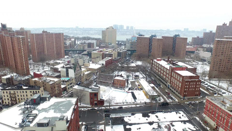 aerial moving over housing projects covered in snow in winter in NYC
