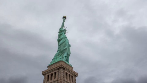 Statue of Liberty with base on foggy day - 4K upward side angle timelapse in New York City
