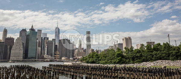 Manhattan skyline with Freedom Tower and buildings and dowels in water