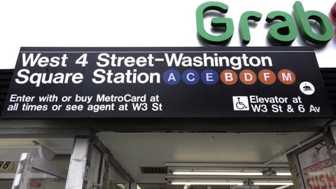 West 4th Street Washington Square subway train station tilting down to man entering entrance in 1080 HD in NYC