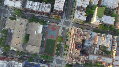 circling over basketball court in Harlem - aerial of courts uptown