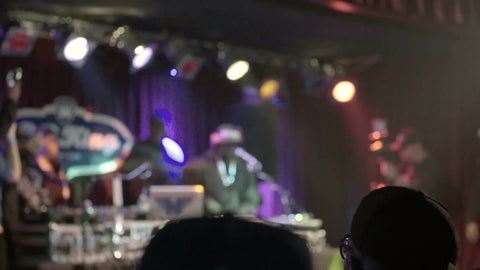 Hip Hop legend DJ Funkmaster Flex spinning records in BB Kings under bright lights on stage