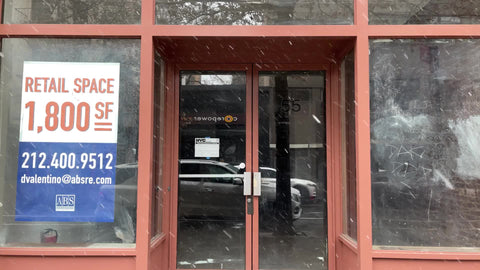 empty retail space with 800 number snowing winter New York City NYC