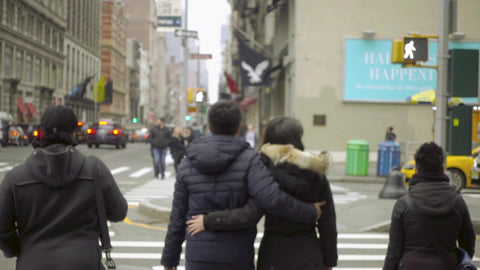 Asian couple crossing street together on Houston Street crosswalk cold winter day Manhattan NYC