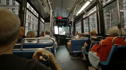 interior MTA bus riding in Manhattan - passengers speaking spanish on summer day in NYC