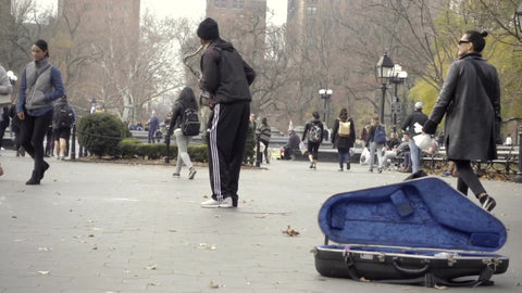 cool saxophone player making music in Washington Square Park for the public