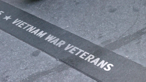 Vietnam War Veterans plaque on sidewalk - disrespectful feet walking over it - people stepping on sign with shoes