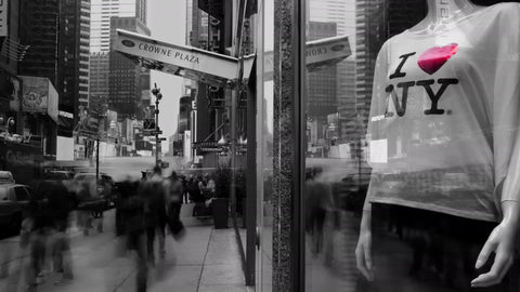 black and white scene in Midtown Manhattan with I Love New York T-shirt in window