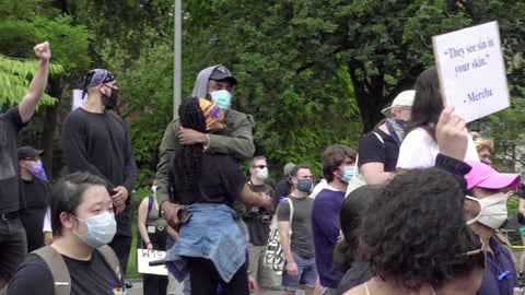 Black man holding Black woman at BLM rally in New York City