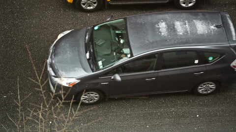 taxi cab driving on street - overhead view - cars on road with snow in winter