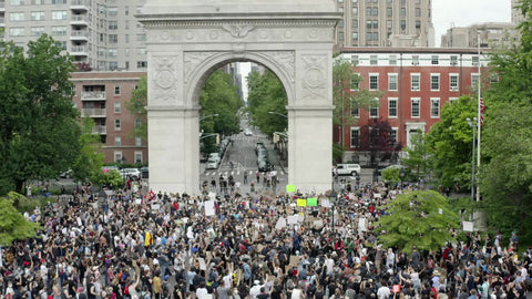 Washington Square Park arch with crowded Black Lives Matter rally people with signs in New York City NYC