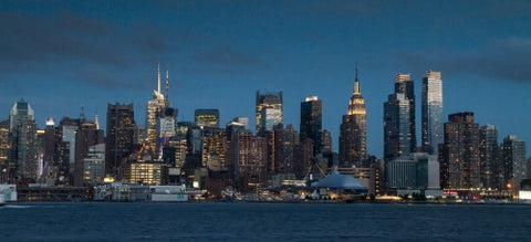 Manhattan skyline in early evening on beautiful night with Empire State Building lights