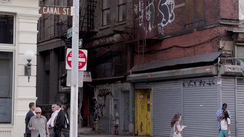 Canal Street sign in Chinatown - people crossing street with do not enter in alley - summer day