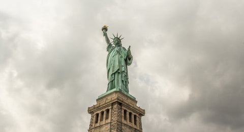 Statue of Liberty on cloudy day - far shot with full body and base