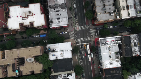 aerial flying over traffic tilting up to Manhattan skyline buildings NYC