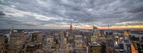 Manhattan at sunset from high view with Empire State Building and city lights in NYC